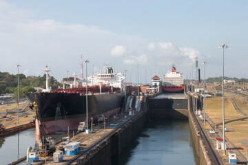 Gatun locks Panama Canal with one large container ship and a tanker pass though the three tiers of...