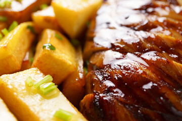 juicy bbq steak with fried potatoes close-up, unhealthy food, tasty food