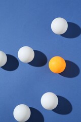 Many ping pong balls on blue background, flat lay
