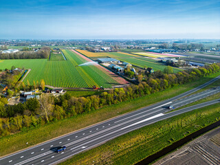 Aerial panoramic view of the Dutch countryside featuring farmland, green fields, forests, and a...