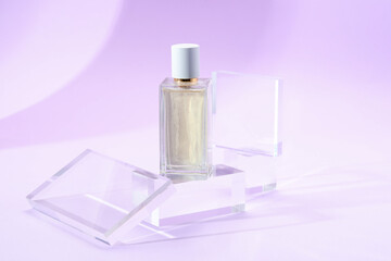 Stylish presentation of perfume bottle on violet background, closeup