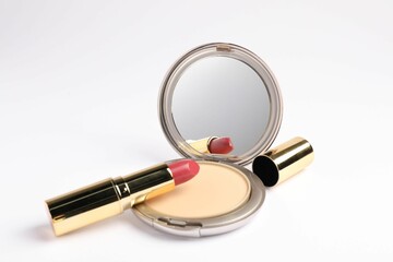Open face powder with mirror and lipstick on white background
