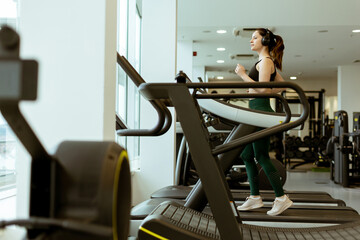 Energizing workout session at a modern gym with a determined individual jogging on a treadmill