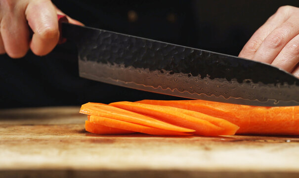 Female Chef Slicing Carrots into Julienne Strips.