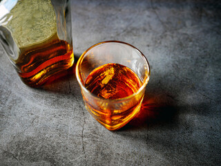 Strong alcohol drink and whiskey bottle Whisky in glass with ice, Whisky, bourbon or cognac. Hard...
