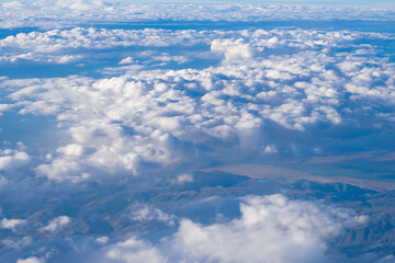Fototapeta premium Aerial cloudy sky view. Cloud view from plane. Sky in cloud. Cloudscape with cloudy weather. Cloud and cloudscape aerial sky. Aerial cloudscape view covered with cloud. Dramatic cloudscape