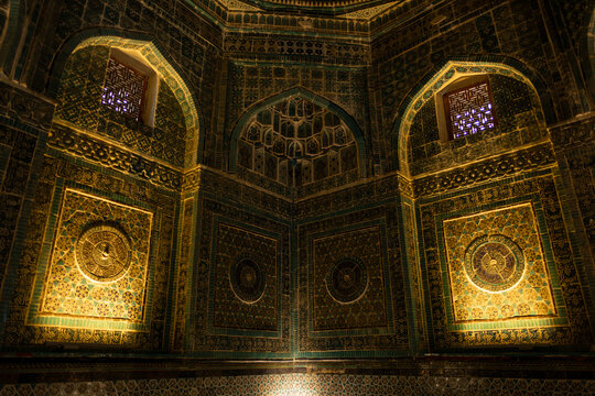 Interior of Shah i Zinda mausoleum in Samarkand Uzbekistan with intricate Islamic tile patterns, golden illumination, Arabic calligraphy, geometric wall decorations in traditional architectural style