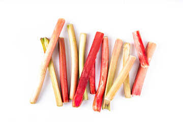 Raw fresh organic rhubarb stems on white background, bunch of homegrown pink and green rhubarb ready for cooking dish, dessert or jam. Summer harvest, cooking ingredient