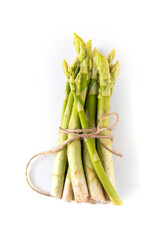 Raw fresh organic asparagus stems on white background, bunch of homegrown green asparagus ready for...