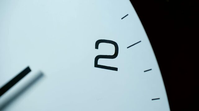 Timelapse revealing white clock face with black hands and numbers, tracking time progression toward two clock with precise visual movement through passing moments
