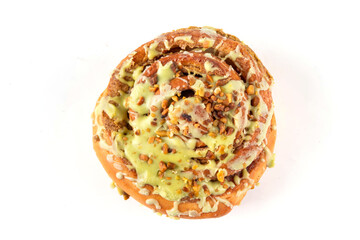 Trendy Dubai chocolate Cinnabon, cinnamon roll with with green pistachio frosting topping, Dubai chocolate filling and sprinkled with kataifi and pistachio nuts