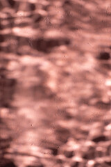 Mediterranean pink terracotta color plaster background with under water sun shadows.