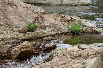 Idyllic stream carved into the rock of a river