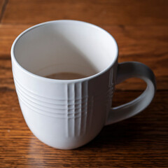 partially full coffee mug with tea or coffee