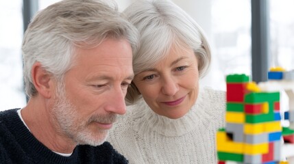 Couple focuses intently on building a colorful toy blocks structure together in their spacious apartment, kidults concept