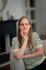 Fototapeta premium A visually impaired woman relaxing at home in an armchair