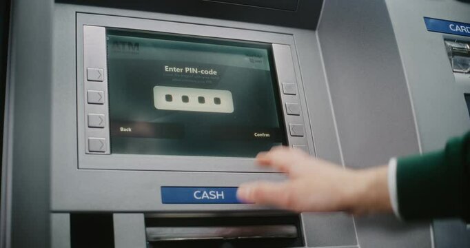 ATM User Entering PIN Code on ATM Keypad for Money Withdrawal. Error Message on Cash Machine Screen About Cancelled Transaction Due to Incorrect PIN Code. Cash Transactions, Banking System. Close Up.