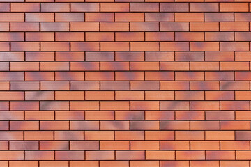 The surface of the wall is made of decorative clinker brick in red color