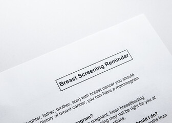 Breast cancer screening reminder notice received by mail. Book annual mammogram for risk and age group. Concept for breast cancer prevention, early detection and mammography. Selective focus.