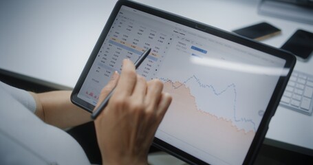 Female Stock Exchange Trader Monitoring and Analyzing Real-Time Stocks, Market Charts in Online...