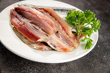 Fototapeta premium Sardine raw fish fillet seafood anchovy filet fresh delicious gourmet food background on the table rustic food top view copy space pescetarian diet