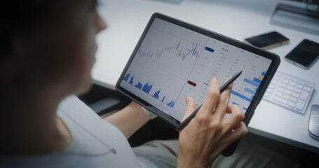 Female Stock Exchange Broker Monitoring and Analyzing Real-Time Stocks, Market Charts in Online...
