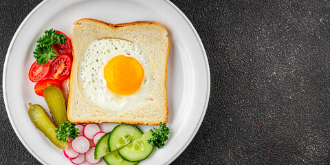 Fried gashouse eggs in bread egg in the basket delicious snack breakfast in a bowl fresh delicious gourmet food background on the table rustic food top view copy space