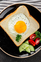 Fried gashouse eggs in bread egg in the basket delicious snack breakfast in a bowl fresh delicious gourmet food background on the table rustic food top view copy space