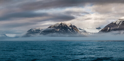 Moody view of East Fjords from ferry arriving in East Iceland at dawn