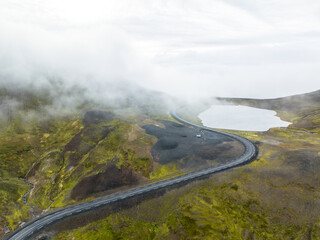 Aerial view of Road 94 winding through misty mountains to Borgafjordur Eystri...