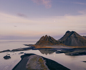 Twilight aerial view of Brunnhorn mountain and black sand coastline, Iceland...