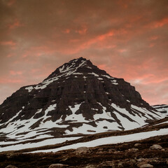 Golden hour light over snow-capped peaks in Faskrudsfjordur, East Iceland...