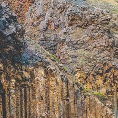 Basalt columns near Litlanesfoss waterfall in East Iceland's rugged canyon...