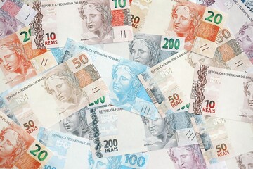 Brazilian reais banknotes. The current Brazil real money bills lies on table in big amount