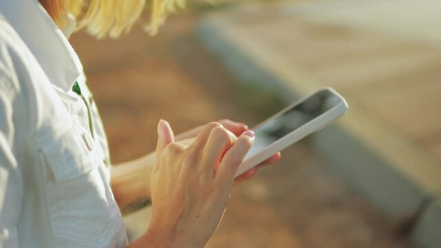 Female hands swiping smartphone screen, interacting with digital content, showcasing seamless wireless communication technologies and touch interface connectivity.Business, technology, communication