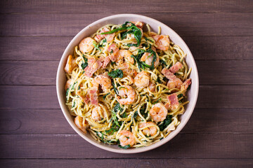 Prawn and bacon pasta with spinach. Spaghetti. View from above, top view
