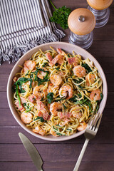 Prawn and bacon pasta with spinach. Spaghetti. View from above, top view