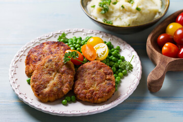 Fish cakes with green peas. Fish patties or burgers. View from above, top studio shot