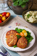 Fish cakes with green peas. Fish patties or burgers. View from above, top studio shot
