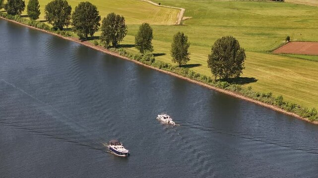 22th of May 2025 - aerial view of the river Maas in Brabant along a dike with trees
