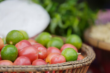vegetables tomatoes, limes in a basket
