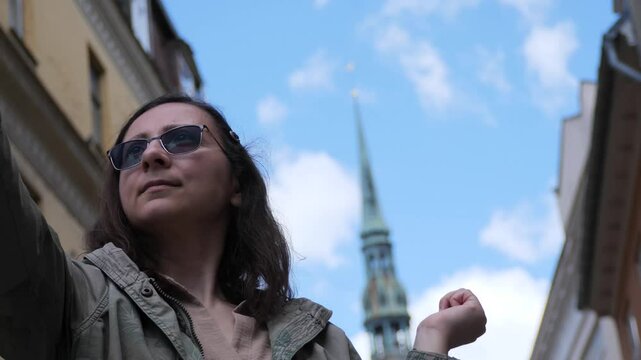 Woman Taking Selfie with Smartphone in European City