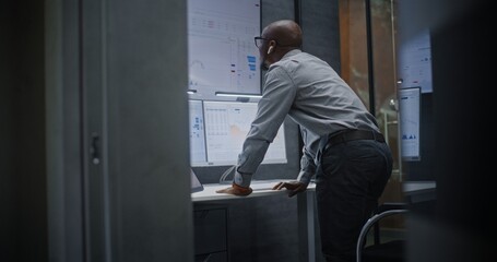 Stock Broker Shouting During Call, Soaking Financial Loss, Monitoring Real-Time Stocks and Exchange Market Charts in Office at Night. African American Investment Agent Angry About Bad Economy News.