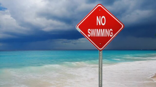 "No swimming" sign on the beach.