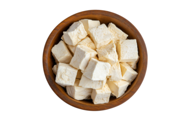 Heap of diced tofu cheese in wooden bowl isolated on transparent background