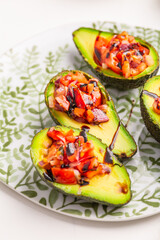 Vegan appetizers, avocados filled with bruschetta and balsamico vinaigrette
