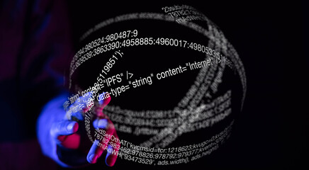 A hand interacts with a 3D holographic sphere displaying lines of code, representing data and...