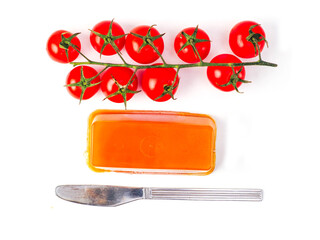Portion of pate and fine cherry tomato on wine and table knife on white color background. Premium...