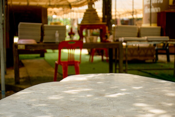 Sunlit Stone Tabletop with Blurred Background of Outdoor Setting, White marble table for product display.