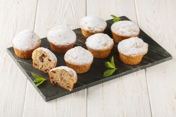 Stollen muffins fruit bread with dried fruit and marzipan coated with powdered icing sugar closeup...